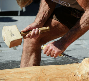 Midsection of carpenter working outdoors