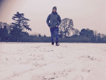 Man standing on snow covered land