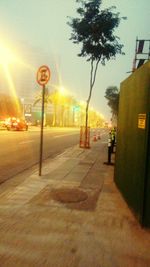 Illuminated street light on road