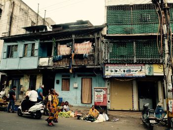 People on mahatma gandhi road against buildings