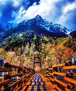 Scenic view of trees and mountains against sky