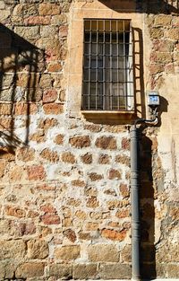 Low angle view of window on wall of old building