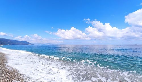 Scenic view of sea against blue sky