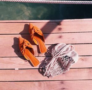 High angle view of shoes on wooden table