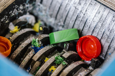 Plastic bottle caps being recycled in machinery