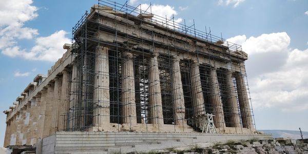 Low angle view of old temple against cloudy sky