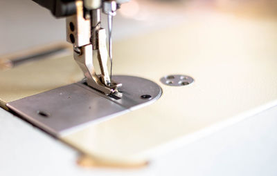 Closeup the sewing machine and thread item at the old sewing machine with vintage style.