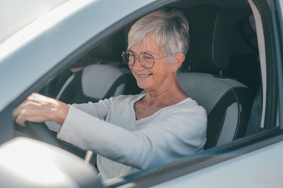 Portrait of woman sitting in car