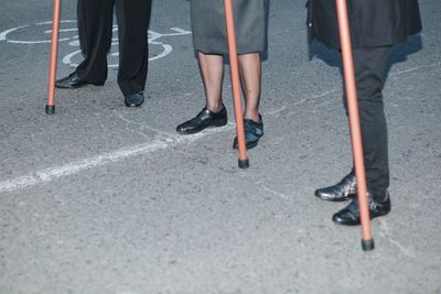 Low section of people standing on road