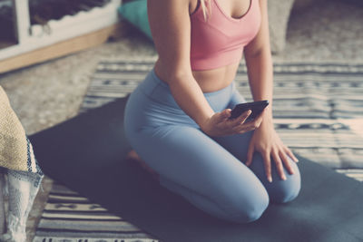 Midsection of woman using mobile phone