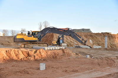 Excavator during excavation at construction site. backhoe on foundation work in sand pit. 