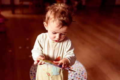 Boy looking away while sitting on floor