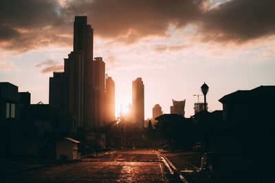 Silhouette of city at sunset