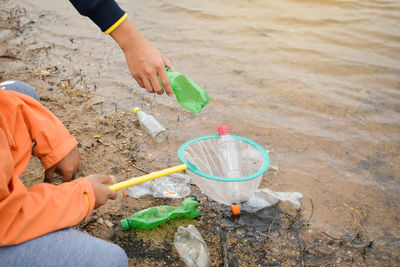 Volunteers cleaning lakeshore at forest