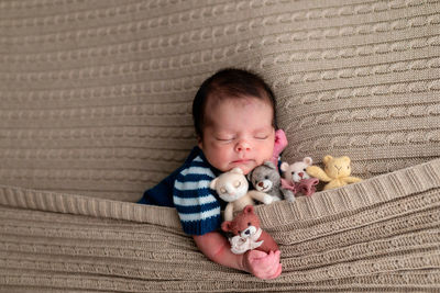 High angle view of cute baby boy with teddy bear