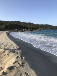 Scenic view of beach against clear sky