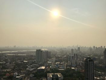 Aerial view of buildings in city against sky