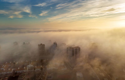 High angle view of buildings against sky during sunset