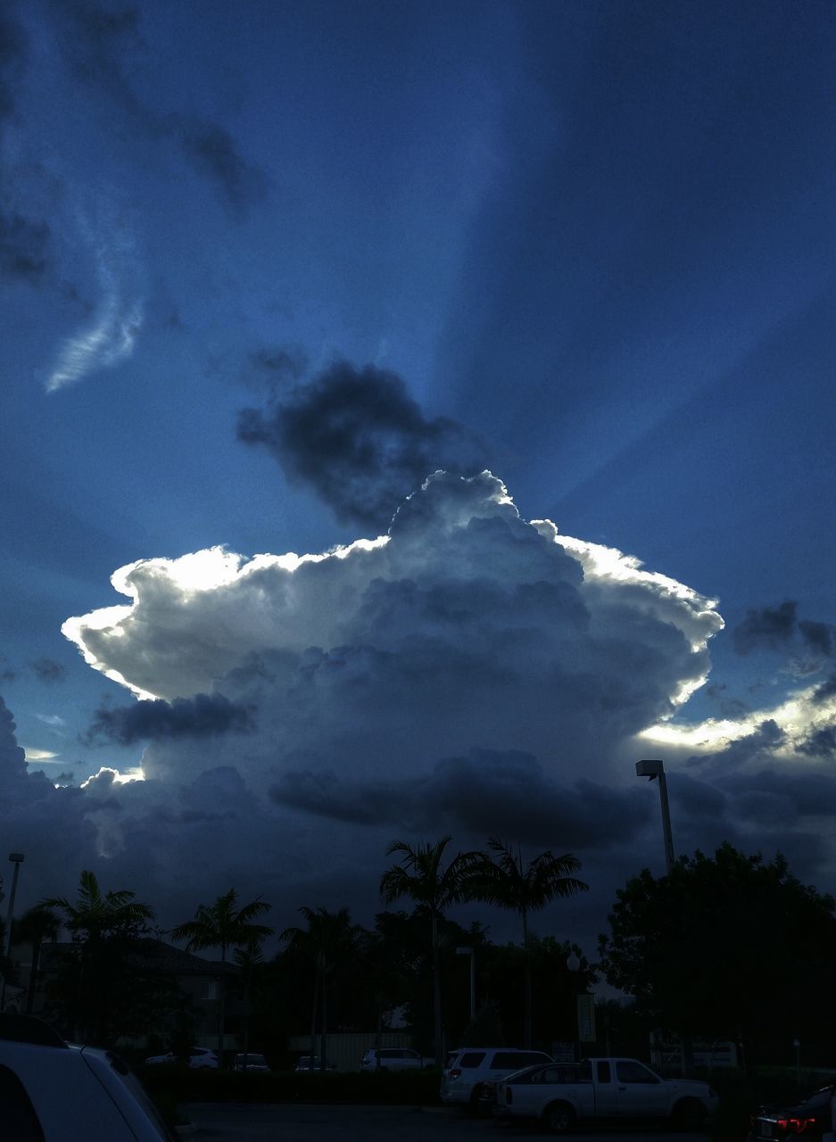 sky, cloud - sky, car, weather, transportation, cloudy, mode of transport, blue, nature, land vehicle, beauty in nature, road, scenics, cloud, tree, street light, storm cloud, outdoors, snow, mountain