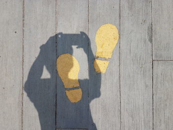 Shadow of person on yellow hand