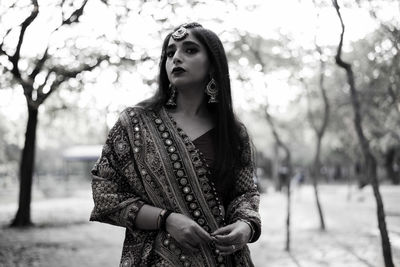 Portrait of young woman wearing traditional clothing standing outdoors