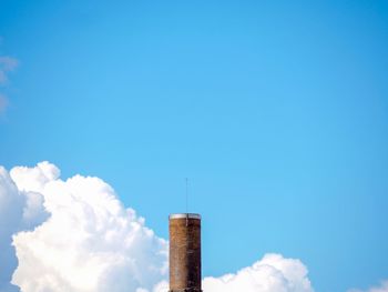 Low angle view of factory against blue sky