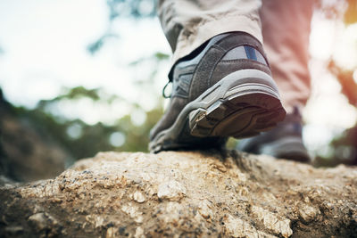 Low section of man standing on rock