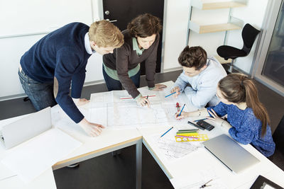 High angle view of professor and students in classroom