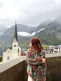 Rear view of woman standing against mountain