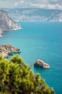 High angle view of sea and rocks against sky