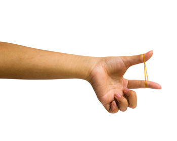 Close-up of hand holding eyeglasses against white background