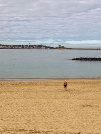 Man on beach against sky