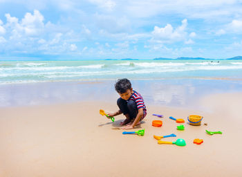 Boy playing with toy on beach