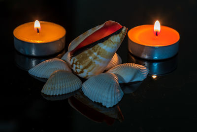 Close-up of burning candle on table