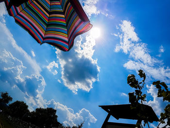 Low angle view of multi colored beach umbrella against sky