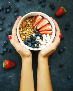 Directly above shot of woman with fruits in bowl