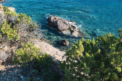 High angle view of rocks on sea