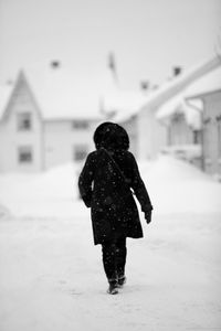 Woman standing on snow covered park