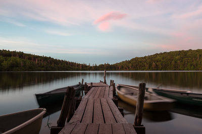 Boats and wooden jetty on lake
