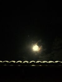 Low angle view of illuminated lights at night