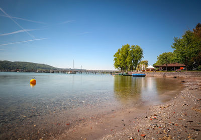 Scenic view of sea against clear blue sky