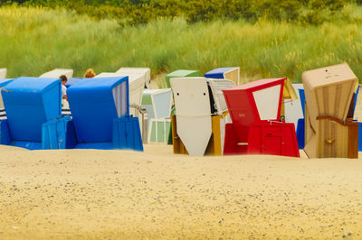 Multi colored chairs on sand at beach