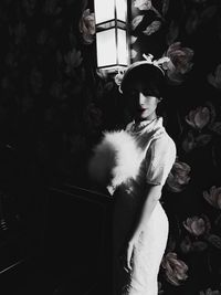 Midsection of woman standing at home