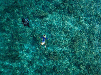 High angle view of people swimming in sea