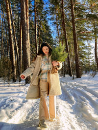 Young woman standing on snow covered landscape