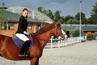 Portrait of young woman riding horse