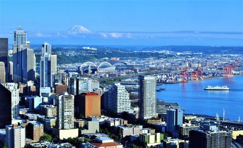 High angle view of city by sea against sky