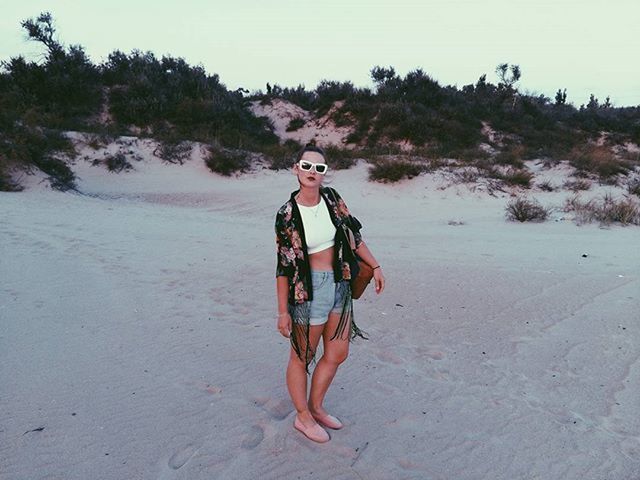 young adult, lifestyles, person, leisure activity, full length, casual clothing, young women, looking at camera, portrait, beach, sunglasses, front view, sand, smiling, happiness, standing, vacations