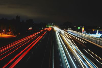 High angle view of light trails on highway at night