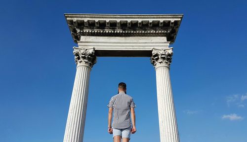 Low angle view of statue against clear blue sky